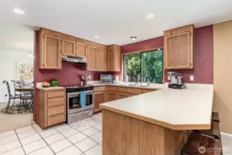 Kitchen with tile floor has ample counters and storage space