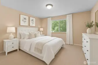 The primary bedroom features a walk-in closet and an ensuite bathroom. [This photo is virtually staged]
