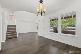 Open floor plan with high ceiling