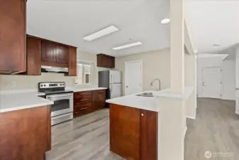 Kitchen features stainless steel appliances, quartz countertop.