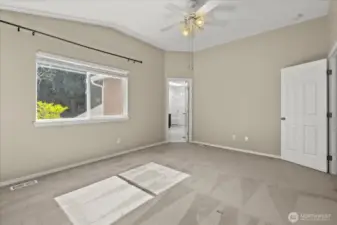 Primary bedroom with vaulted ceiling.