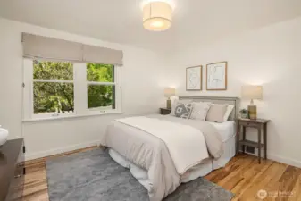Primary bedroom with large windows.
