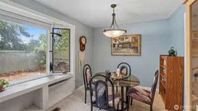 Dining room adjacent to living room received natural light.