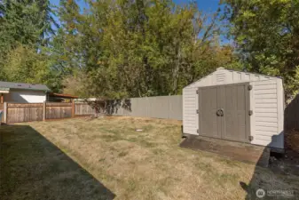 Fully fenced rear yard with garden shed.
