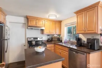 Renovated kitchen with stainless appliances.