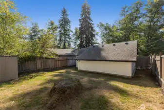 Fully fenced and separated from the larger home to the right.