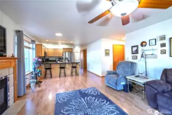 Open living, dining and kitchen areas.