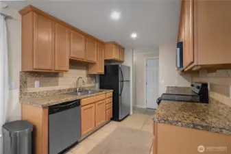 Thoughtfully updated kitchen that features granite countertops and lots of cabinets.