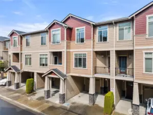 Contemporary townhome exterior with private entry, attached garage, and modern façade in a well-maintained Renton community.