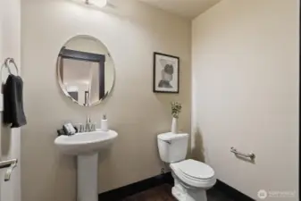 Convenient main-level powder room with pedestal sink.
