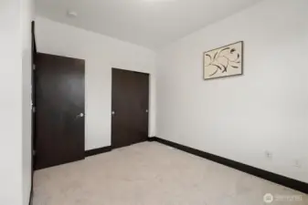 Alternate view of secondary bedroom highlighting closet access.
