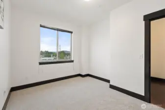 Secondary bedroom with natural light and comfortable proportions.