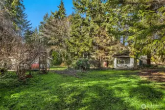 The expansive back yard is flat, usable land with endless potential for gardens, outdoor living, or possible future development.