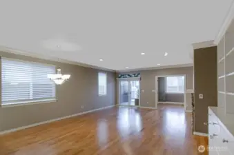 View of the living room showing rich hardwood flooring through main living areas.