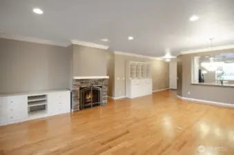 Rock-faced fireplace with white cabinetry offering storage solutions.