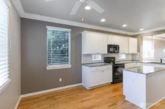 Sunny breakfast nook area can also be used for a sitting area, an office or craft space.