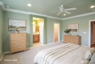 Another view of primary bedroom showing ensuite and large walk-in closet.  New carpet in this room as well.