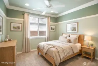 Second bedroom has brand new carpet as well and decorative chair rail, crown molding and ceiling fan.