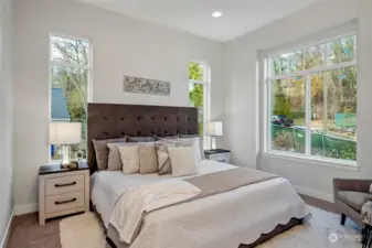 Primary bedroom, large windows flooding natural light