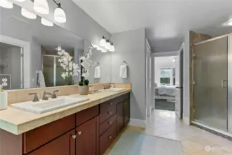 Luxurious ensuite bathroom features a double vanity, walk-in shower...