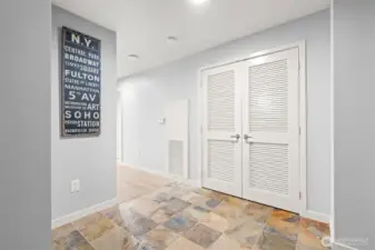 The louvered doors open to the laundry center, where there is extra space for more storage.