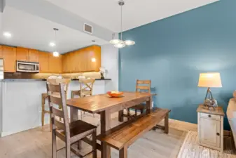You can see there is sufficient space for a dining room table in addition to the breakfast bar seating.