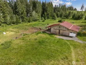 Surrounded by green pastures, this newer barn is the perfect blend of utility and rural charm.