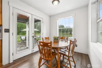The sunlit breakfast nook provides direct access to the back terrace—ideal for seamless indoor-outdoor gatherings.
