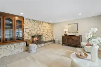 Large room adjacent to front entry has original mid-century rock fireplace surround. Used in the past as a dining room, this is a terrific space for entertaining!