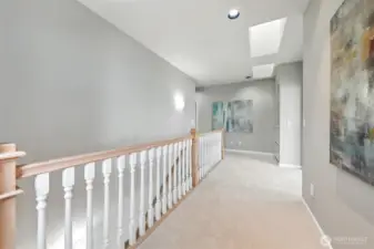 Ascend the staircase to the second level complete with a wide landing with high ceilings and skylights.