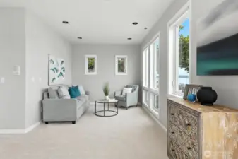The sitting area in the primary suite is the perfect place to relax, read a book, have a cup of coffee and watch all of the boating activity and sea planes right out your windows.