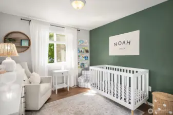 2nd bedroom with faux wood blinds, a deep green wall focal point and views of the backyard.