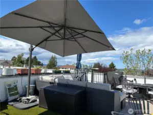 Summertime in the city. This rooftop is larger than most and most furniture conveys with sale.