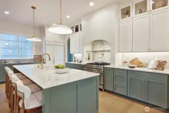 An entertainer's dream kitchen: outfitted with high-end appliances, marble countertops, a 9-foot island, pot filler, and abundant storage space.