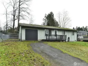 Single car garage with long driveway.