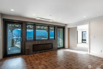 Indoor outdoor living with the double-sided fireplace and twin doors opening to the patio.  The living room offers relaxing space all year round.