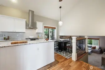 Vaulted ceiling also in kitchen, casual dining area; wrought iron railing is nice accent!