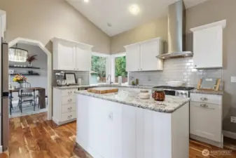 Updates have included granite countertops, backsplash, cabinets, and appliances.  The wood laminate flooring throughout the main floor is lovely!!