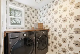 Laundry area (lower level) has been updated with nice "folding area" over the washer/dryer and new stylish wallpaper!