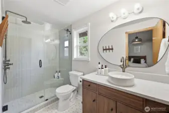 Beautifully remodeled primary bathroom:  shower stall re-tiled, as well as floor! Quartz countertop...updated sink.