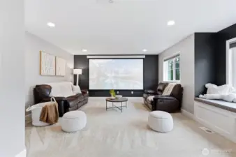 Impressive media room with projector and theater screen plus motorized blinds for awesome movie nights!