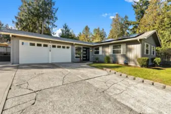 The spacious two-car garage features built-in shelving, offering plenty of storage and organization options.