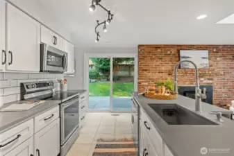 Step into this stunning kitchen, featuring crisp white cabinets, elegant quartz countertops, and sleek stainless steel appliances!