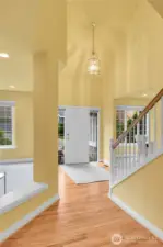 Magnificent foyer with soaring ceiling, polished-brass and beveled glass pendant chandelier. Oak-hardwood floor. Signature William Buchan millwork throughout. Entry hall with barrel-shaped passageway and entry coat closet with storage area behind.