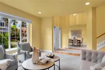 Living room off entry. Traditional divided-light windows with window screens and two-inch blinds. 9-ft high ceiling with additional accent lighting. Dining room across from Living room.