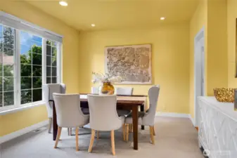 Dining room across from Living room. Added adjustable accent lighting at buffet alcove and east side of dining area.. Signature William Buchan millwork. Traditional divided-light windows with window screens and two-inch blinds. High ceiling with recessed lighting. Doorway to kitchen.