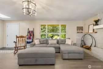 Comfort meets character in the light-filled living room—ideal for gathering, relaxing, or simply enjoying the view out front.