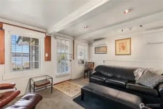 Lower level family room with exterior door leading to a small little nook.