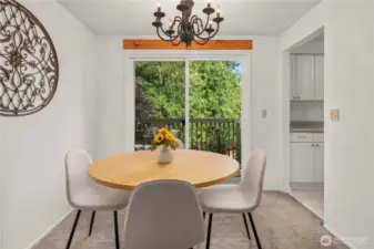 Dining space with slider door leading to the deck looking over the backyard