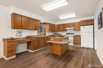 The welcoming kitchen has a special built-in chair height eating counter attached to the island for "lunch-counter"  style dining.  The convenient desk/work station makes a great landing spot for phone charges, laptops, or mail.